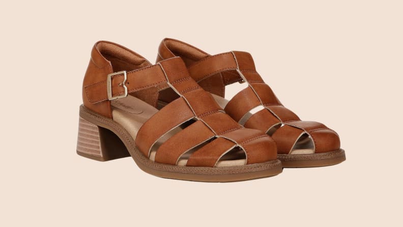 brown leather heeled sandals on beige background