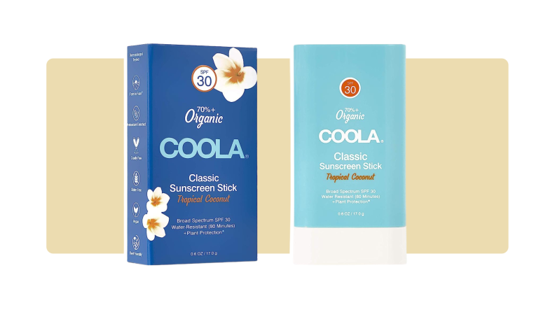 Coola sunscreen stick in front of a yellow background.