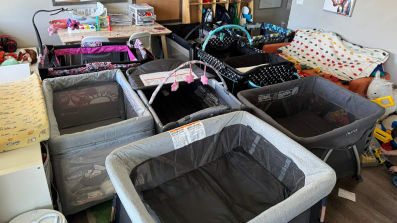 Various playards and pack 'n plays in one room side by side.