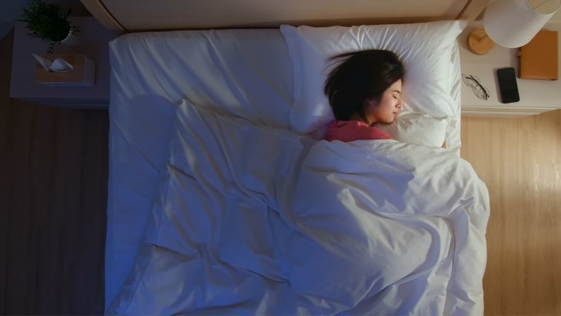 a person lies on their side asleep