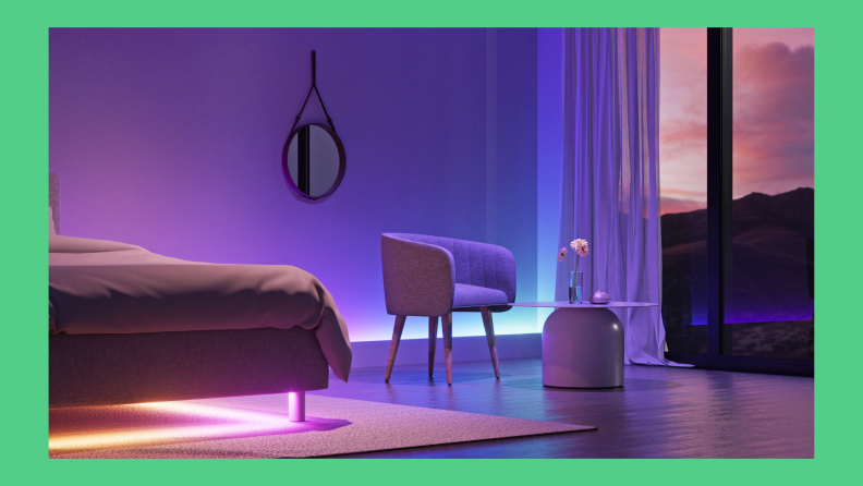 A model room is shown with vibrant lights accenting furniture and walls.
