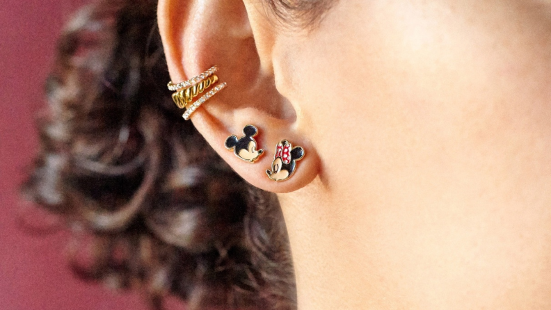 Woman wearing Mickey and Minnie mouse studs