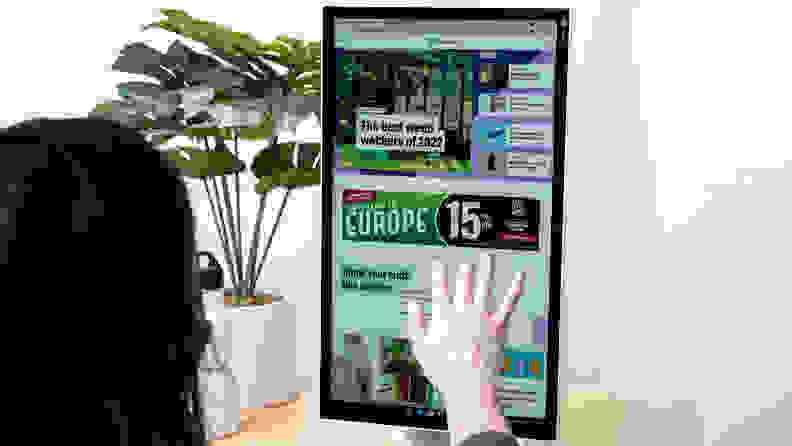 A person touching a computer's display