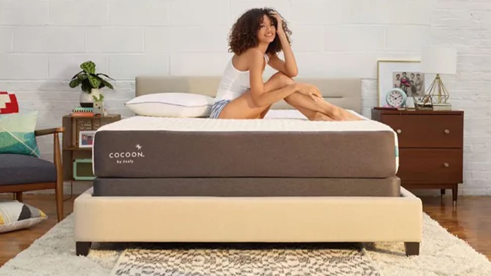 Someone sitting on top of a Cocoon by Sealy Chill mattress.