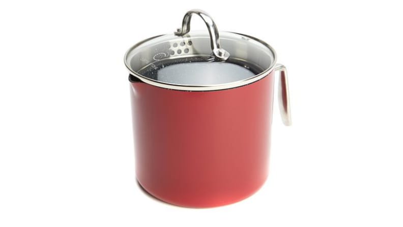 An image of a Curtis Stone saucepan in red, with the lid on.