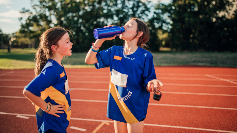 Girls drinking water from a hydroflask