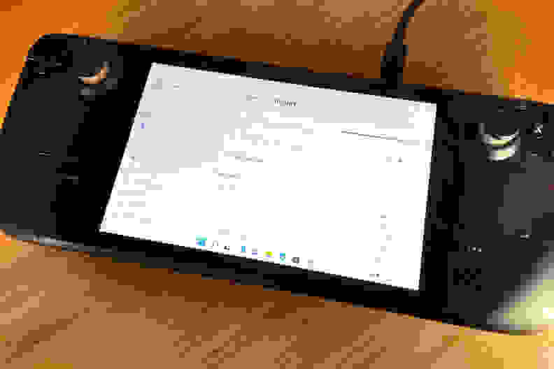 A black handheld gaming console showing part of the Windows 11 OS installation process