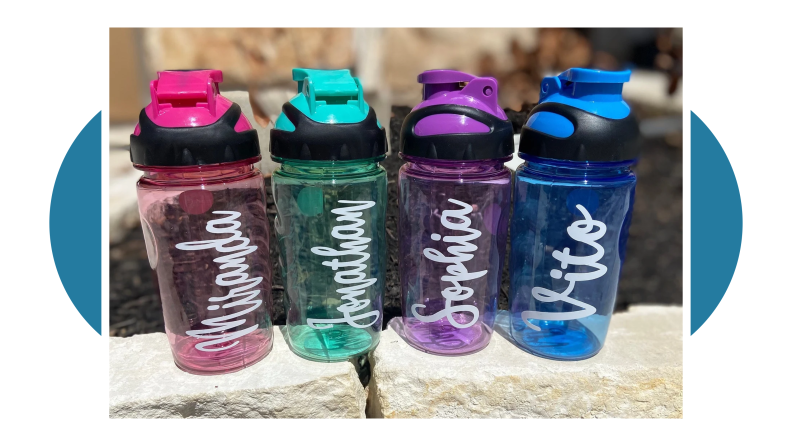 Four water bottles with names printed on them in white paint.