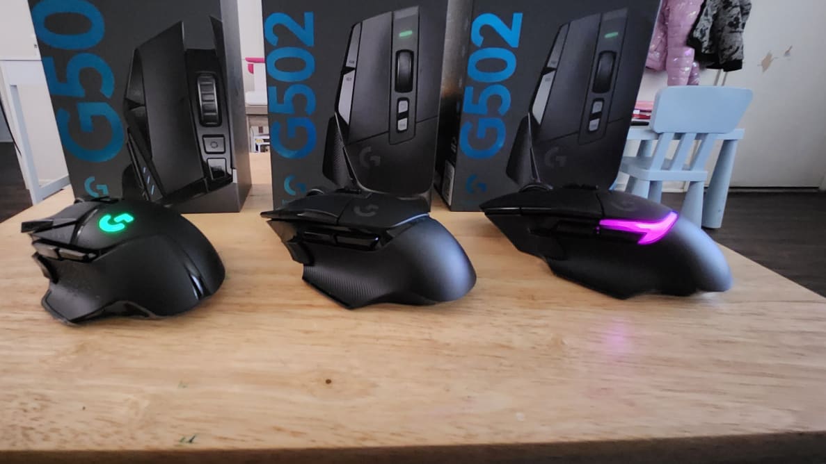 Logitech G502 X Lightspeed gaming mouse side by side with another on tabletop surface.
