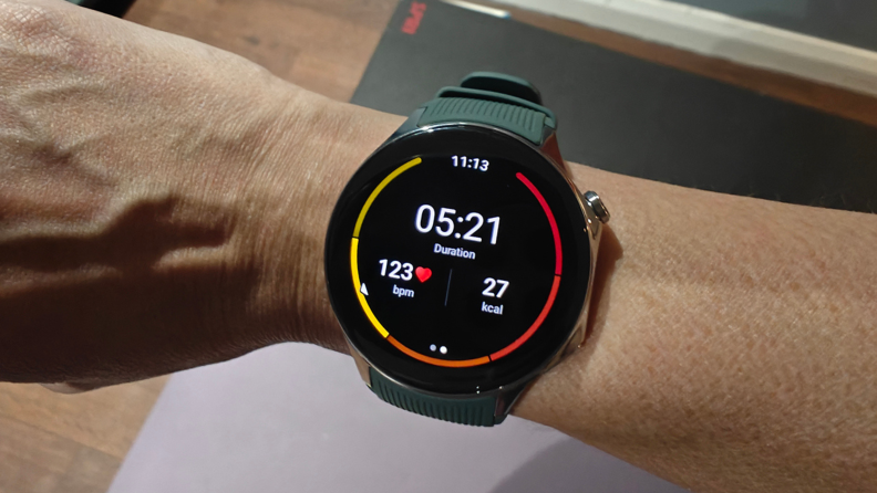The OnePlus Watch 2 display showing duration of movement, heartbeats per minute, and calories burned.