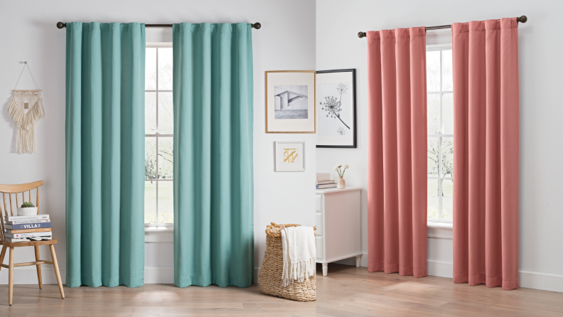 A set of teal curtains and a set of salmon-colored curtains hung up.