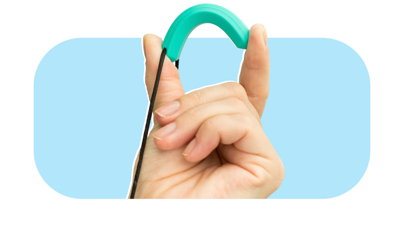 Fingers squeezing teal Tilcare Chew Chew Sensory Pencil Necklace.