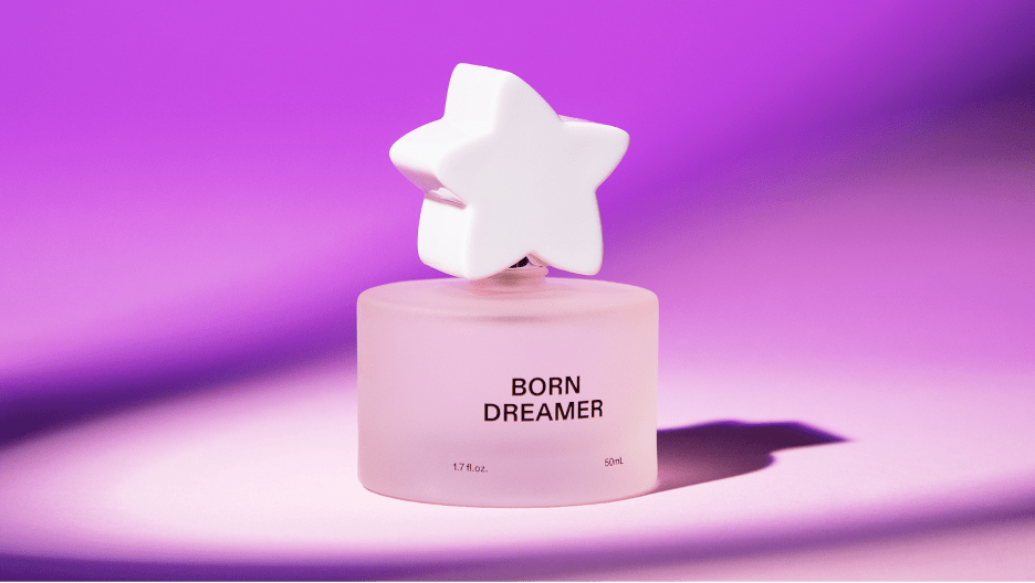 Perfume bottle against a purple background