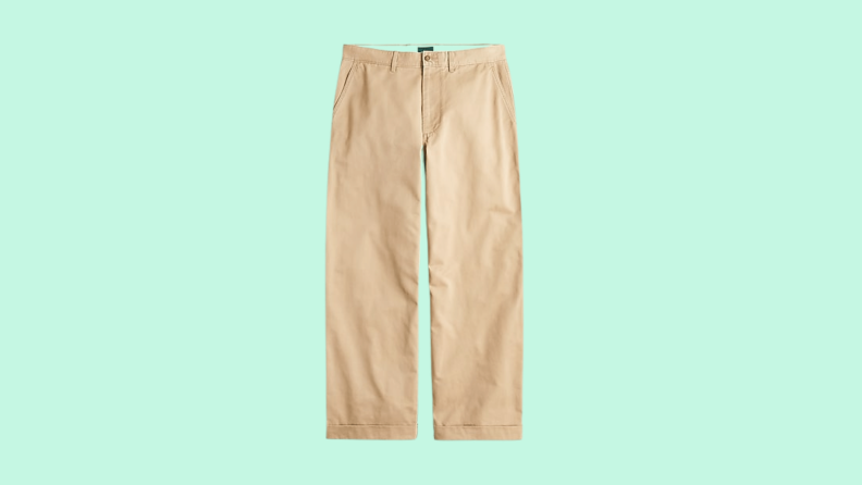 Wide-leg khaki pants against a green background.