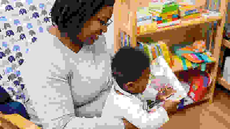 Woman reading book to baby as part of Owlet Dream Lab bedtime routine