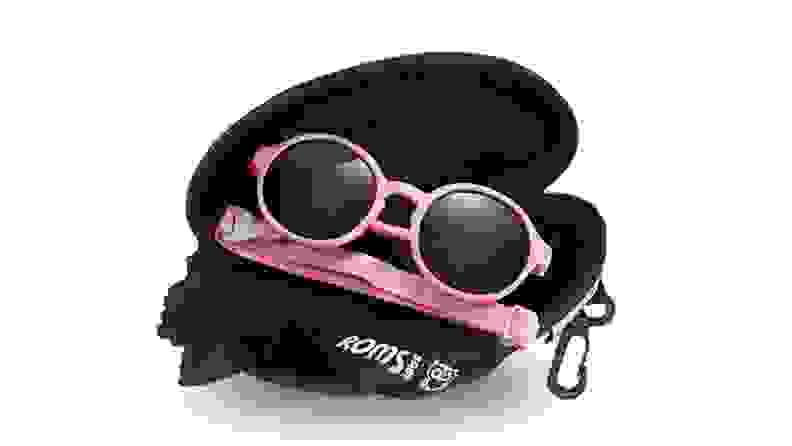 A pair of pink sunglasses on a black case.