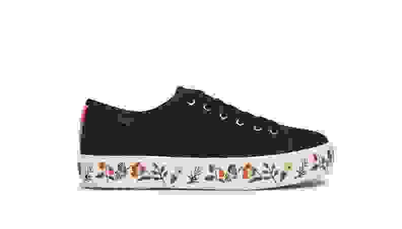 Black Keds sneakers with flowers along the bottom