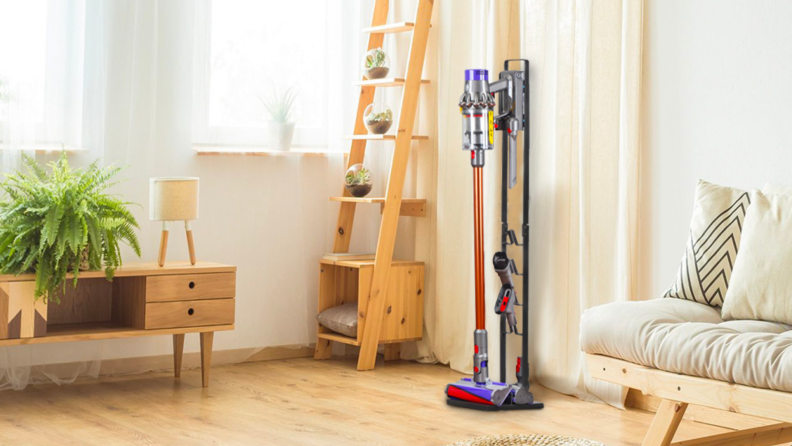 A vacuum cleaner stored on an upright stand.