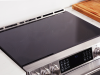 Close-up of the cooktop on a stainless steel induction range.