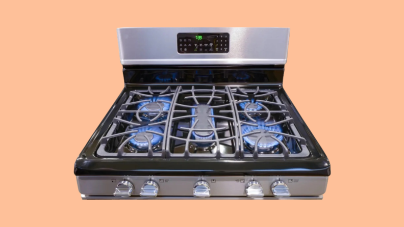The top of a gas range with the burners on.