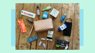 Small toiletry bag with assorted hygiene products scattered all around on tabletop surface.