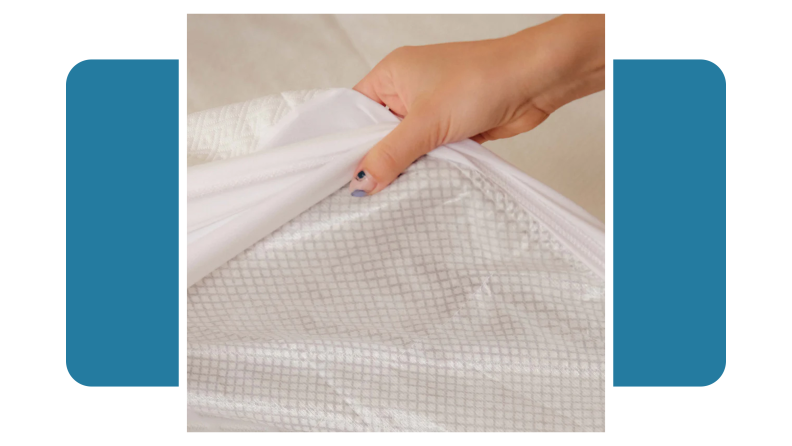 Person lifting up plastic mattress pad on mattress.