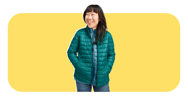 Person smiling while wearing thin green puffer jacket from Primary