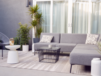 Contemporary patio furniture set-up with a neutral area rug