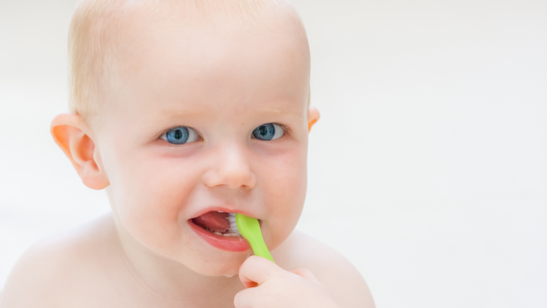 A baby brushing his teeth
