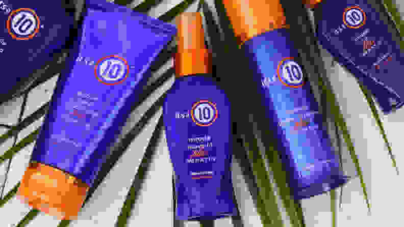 The It's A 10 Keratin line of products laying on top of a palm leaf.