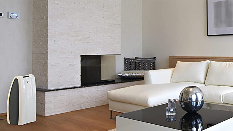 A Vornado air purifier sits in a modern living room.