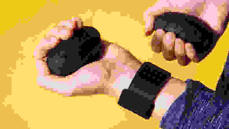 Person wearing Liteboxer wrist straps holds egg shaped weights.