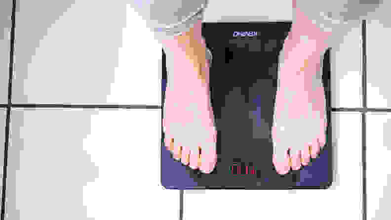 A woman standing on the Renpho smart scale