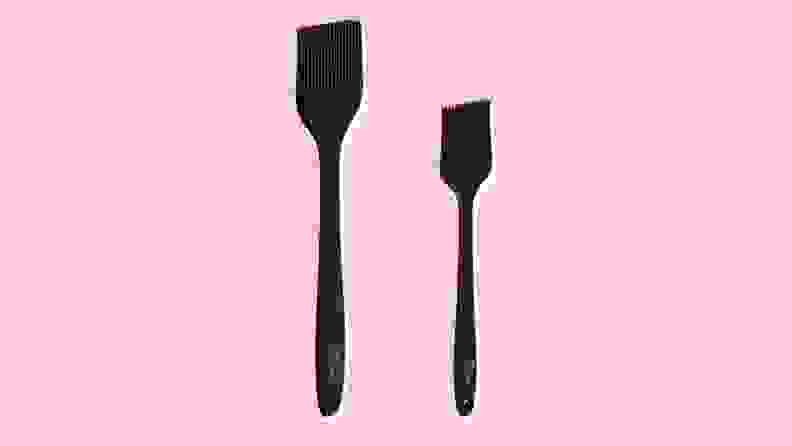 Two grill brushes on a pink background