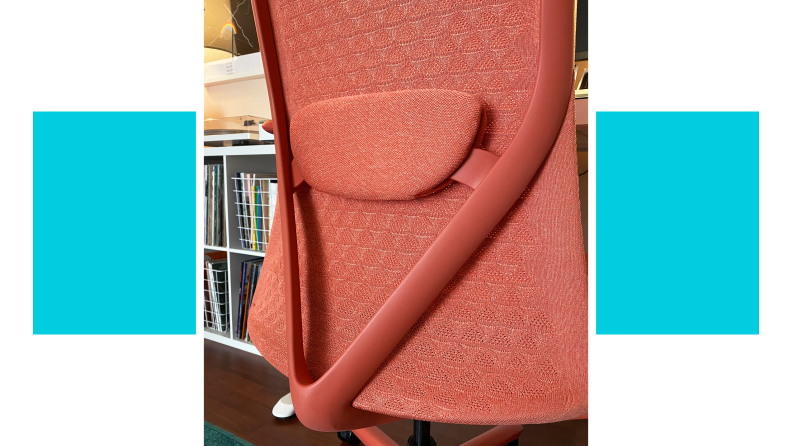 Shot of the V-shaped design on the back of the coral colored Verve chair.