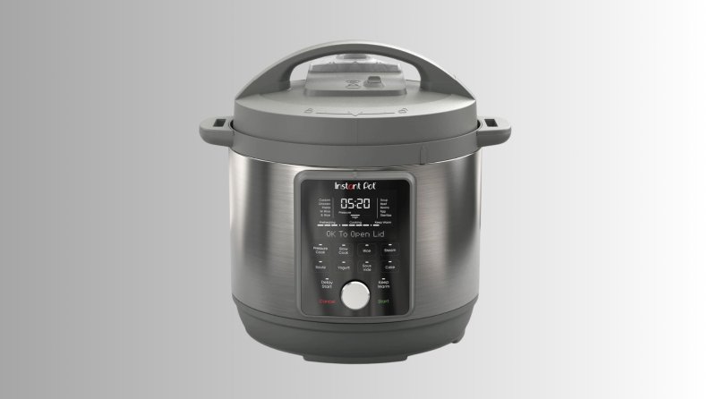An Instant Pot cooker sits on a gray ombre background