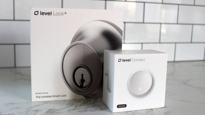 The Level Lock Plus and Level Connect in their packaging on a marble counter.