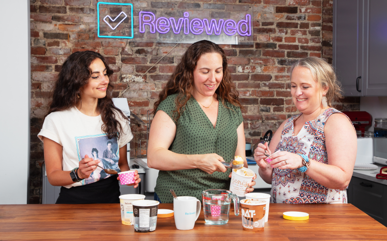 Three people eating dairy free ice cream in front of a countertop.