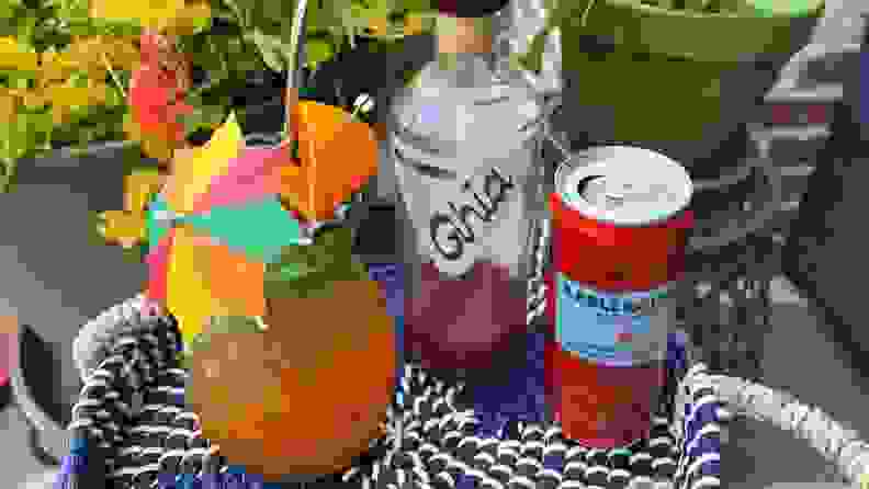 An assortment of mocktail ingredients arranged on a patio table.