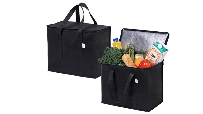 Black insulated grocery bags filled with assorted groceries.