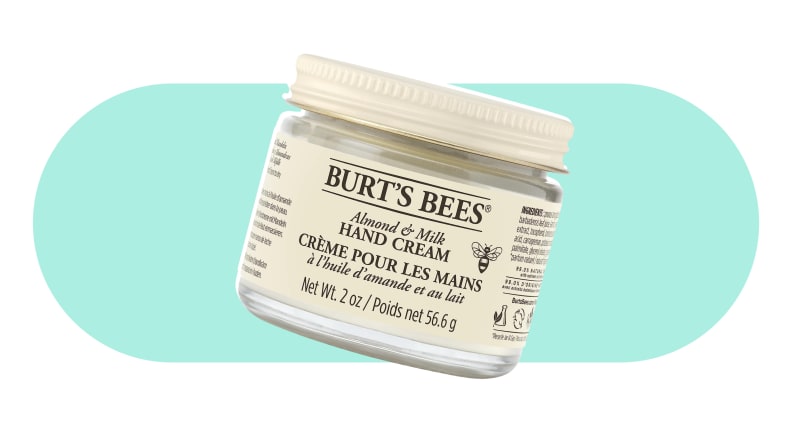 A jar of Burt's bees hand cream on a colorful background