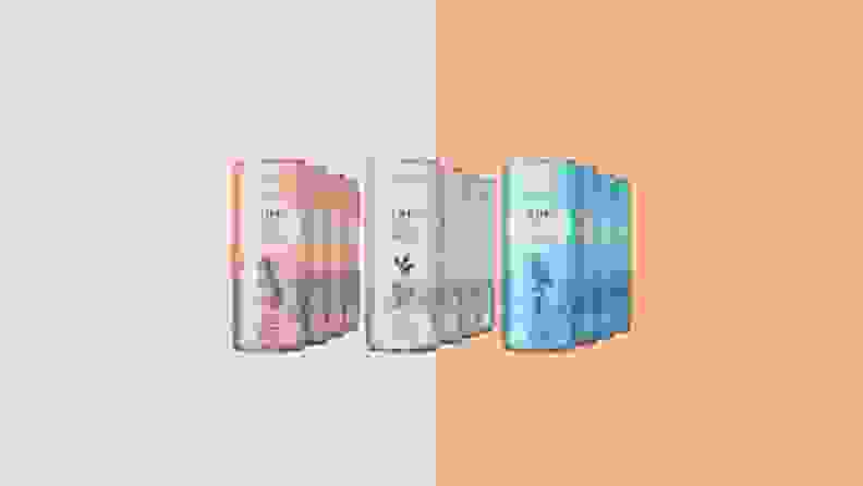 Pink, white and blue Lyre's cans on an orange background.