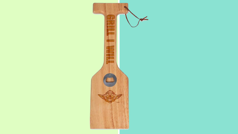 A yoda grill paddle on a green background
