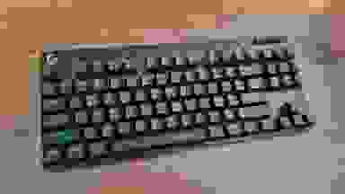 The Logitech G Pro X TKL keyboard on a wood table.