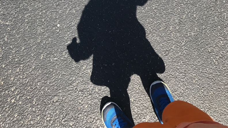 A child's shadow on the road