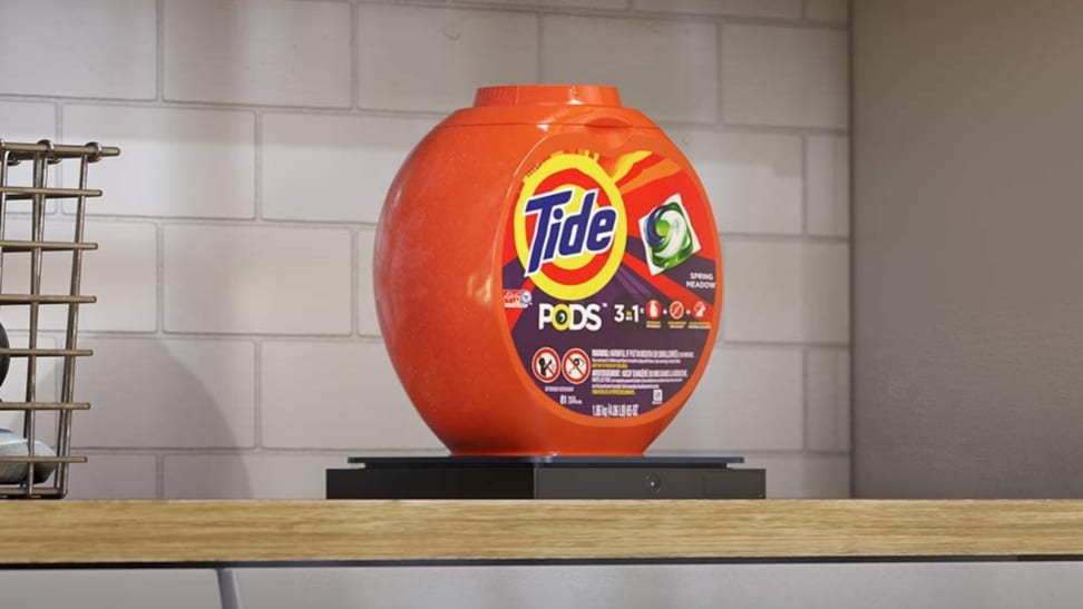 In a laundry room, a container of Tide laundry detergent is sitting on an Amazon Dash Smart Shelf.