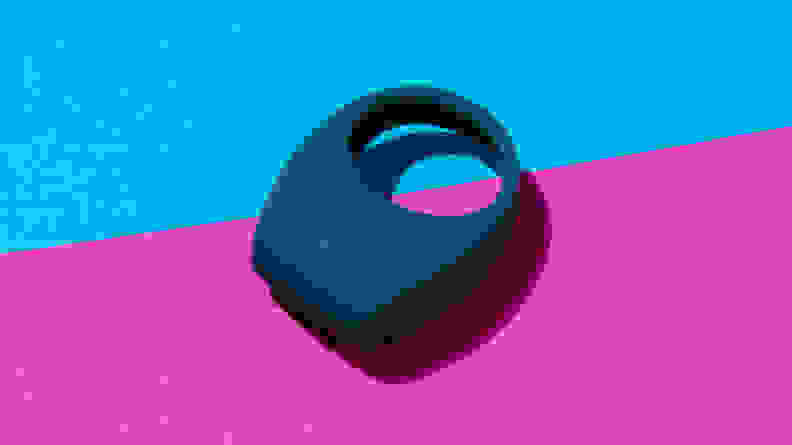 A blue Lelo Tor 2 vibrating cock ring on top of a two-tone pink and blue contrast surface.