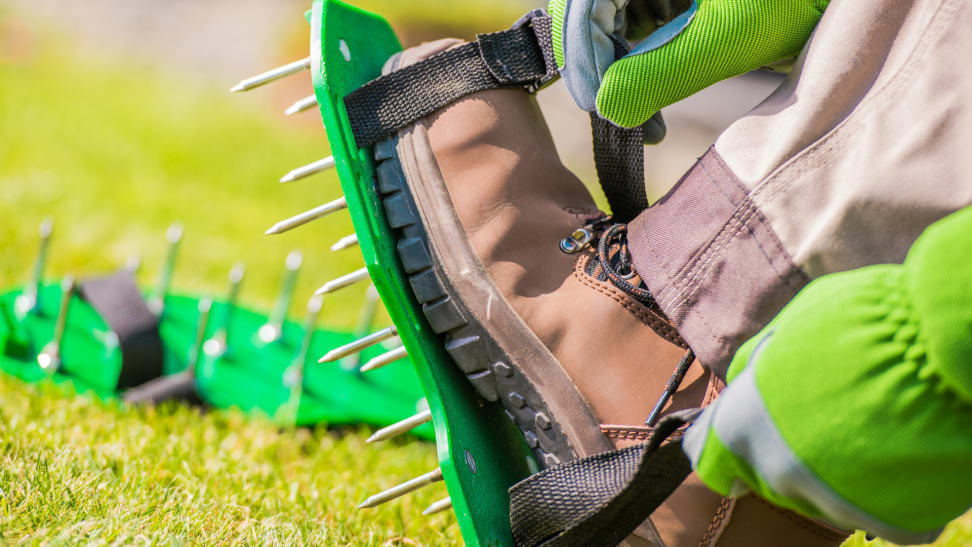 Strapping on aerator shoes to a boot