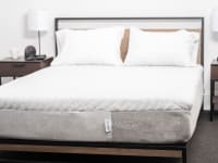 White mattress with pillows but without sheets.