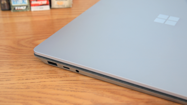 Exterior edge of the gray Microsoft Surface Pro 5 Laptop on top of wooden surface.